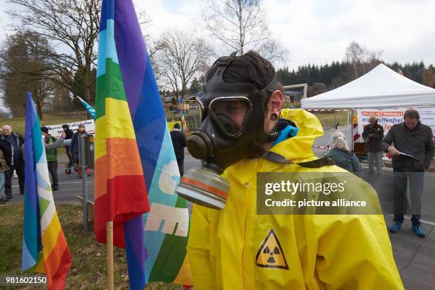 Dpatop - A man wearing a gas mask takes part in a protest calling for the end of nuclear armament and the withdrawal of an alleged last nuclear...