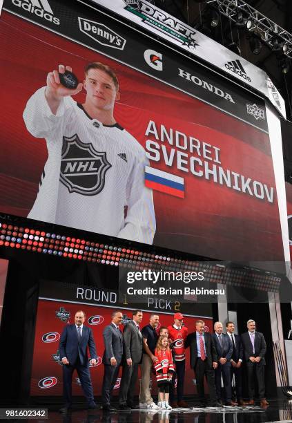 Andrei Svechnikov poses for a photo onstage after being selected second overall by the Carolina Hurricanes while general manager Don Waddell looks on...