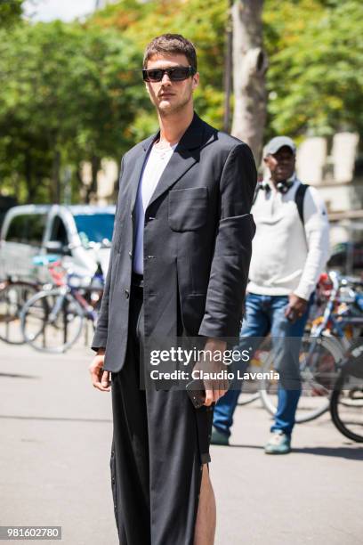 Guido Milani, wearing black long jacket and pants, is seen in the streets of Paris after the Juun.J show, during Paris Men's Fashion Week...