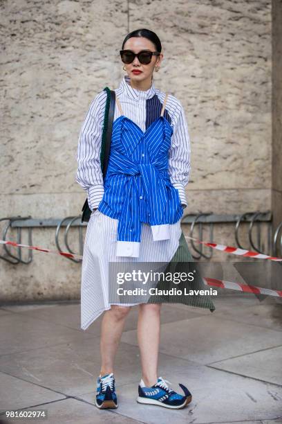 Sherry Shen, wearing a JW Anderson dress and Loewe shoes, is seen in the streets of Paris before the Juun.J show, during Paris Men's Fashion Week...