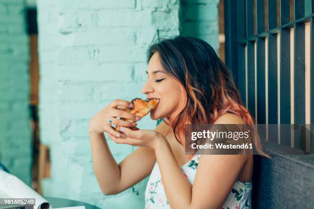 woman eating croissant in coffee shop - 焼き菓子 ストックフォトと画像