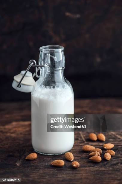 almond milk in swing top bottle - almond milk stock-fotos und bilder