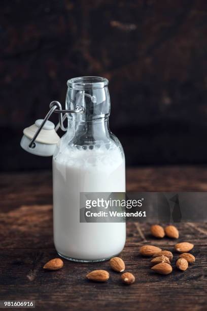 almond milk in swing top bottle - almond milk stock pictures, royalty-free photos & images