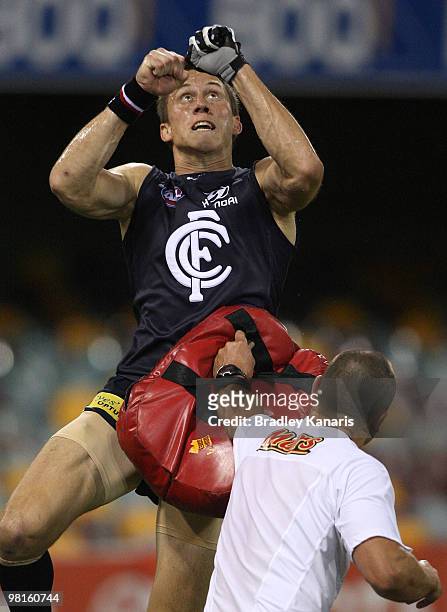 Bret Thornton jumps to take a mark during a training drill at a Carlton Blues AFL training session at The Gabba on March 31, 2010 in Brisbane,...