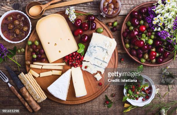 cheese platter with fresh colorful summer berries - cheese board photos et images de collection