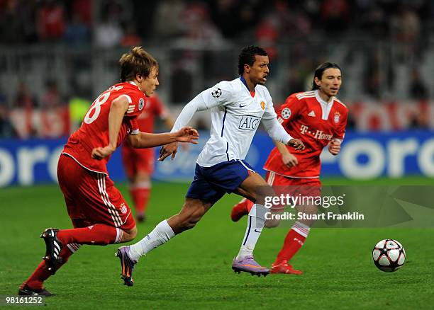 Nani of Manchester is challenged by Holger Badstuber of Bayern during the UEFA Champions League quarter final, first leg match between FC Bayern...