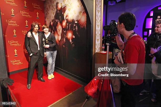 Visitor poses for a photograph with a waxwork model of actor Johnny Depp, left, at Madame Tussauds in London, U.K., on Tuesday, March 30, 2010....