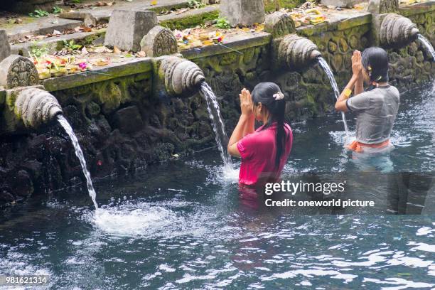 Indonesia. Bali. Gianyar. Praying women in the water of the Hindu temple Pura Tirta Empul.