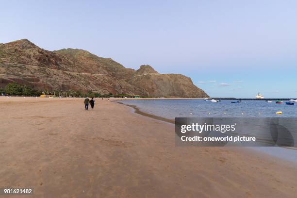 Spain. Canary Islands. Tenerife. On the beach of Playa de Las Teresitas. Beach walk in the evening.