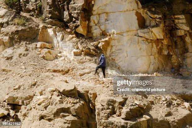 Tajikistan. On the other side of the river you can see how the Afghani side of the road with hand tools is built.