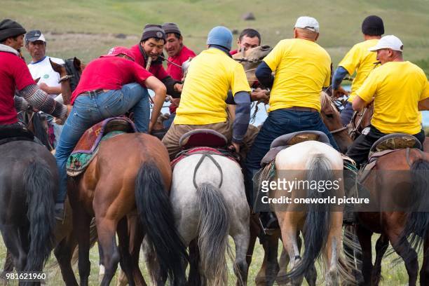 Kyrgyzstan. Osh region. Nomadgames. Men on horses. Participants in goat polo.