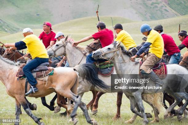 Kyrgyzstan. Osh region. Nomadgames. Men on horses. Participants in goat polo.