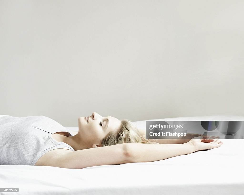 Portrait of woman lying on bed
