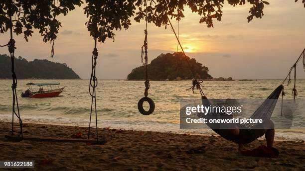 Malaysia. Perak. Pulau Pangkor. In the hammock the day end. Island between Penang and Kuala Lumpur.