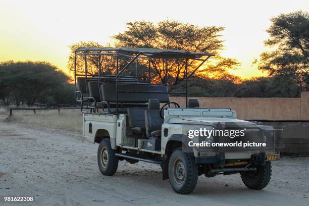 Namibia. Okapuka Ranch. Safari. Game Drive. Safari Jeep in the sunset.