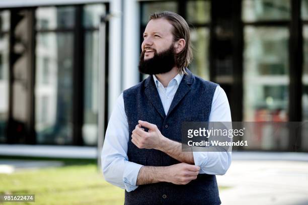 portrait of bearded businessman watching something - rolling up sleeve stock pictures, royalty-free photos & images