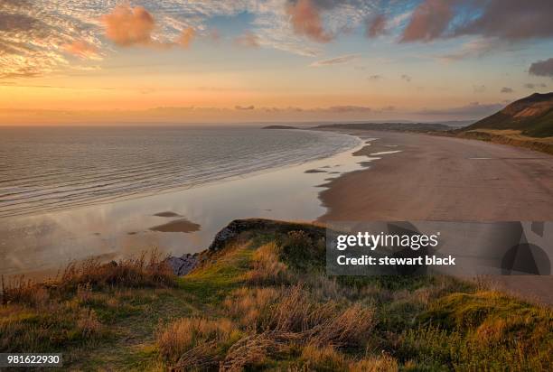 beach at sunset, rhossili, gower, wales, united kingdom - rhossili stock pictures, royalty-free photos & images