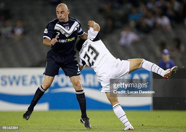 Kevin Muscat of the Victory competes against Kyohei Noborizato of Kawasaki during the AFC Champions League Group E match between Melbourne Victory...