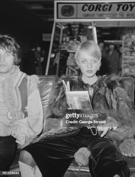 English fashion model, actress and singer Twiggy with her partner and manager, British businessman Justin de Villeneuve, at Heathrow Airport, London,...