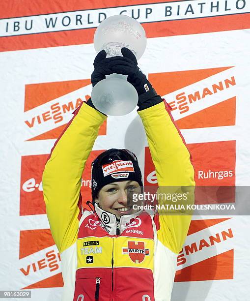 The winner of the women's Biathlon World Cup season 2009-2010 Magdalena Neuner of Germany celebrates with a trophy on the podium in the Siberian city...