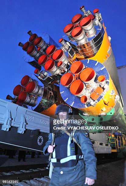 Russian policeman stands near the Russian Soyuz TMA-18 spacecraft at the Baikonur cosmodrome on March 31, 2010. The crew of US astronaut Tracy...