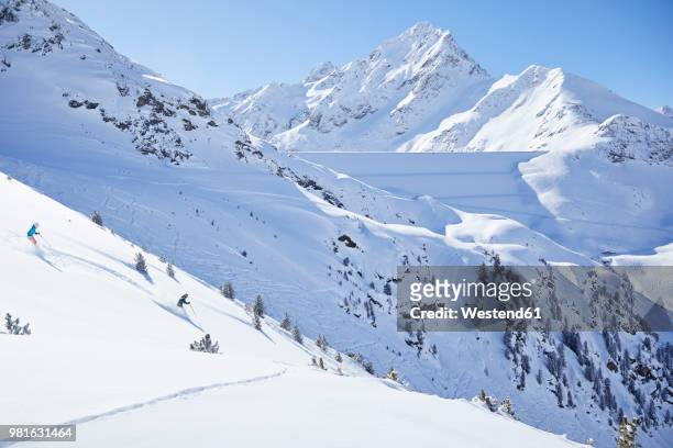 austria, tyrol, kuehtai, couple skiing in winter landscape - kühtai stock-fotos und bilder