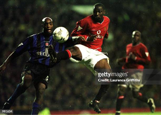 Andy Cole of United hits the ball past Richard Rufus of Charlton during the match between Manchester United and Charlton Athletic in the FA Carling...