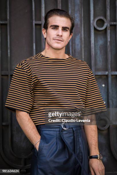 Carlo Sestini, wearing a striped yellow and black t shirt and black Cerruti pants, is seen in the streets of Paris before the Cerruti 1881 show,...