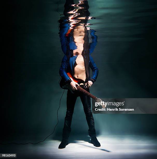 male with electric guitar underwater - open or close button stock pictures, royalty-free photos & images