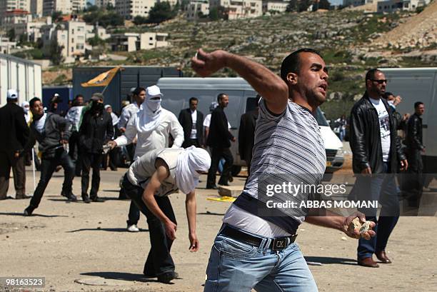 Palestinian protester hurls stones at Israeli soldiers during clashes at the Betunia checkpoint near the Ofer military prison on March 31, 2010....