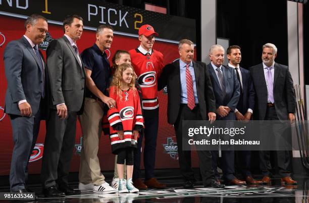 Andrei Svechnikov poses for a photo onstage after being selected second overall by the Carolina Hurricanes while general manager Don Waddell looks on...