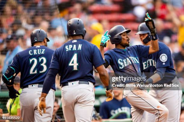 Nelson Cruz of the Seattle Mariners reacts with Dee Gordon, Denard Span, and Ryon Healy after hitting a there run home run during the first inning of...