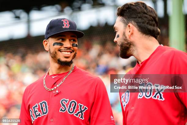 Mookie Betts of the Boston Red Sox reacts with Blake Swihart before a game against the Seattle Mariners on June 22, 2018 at Fenway Park in Boston,...