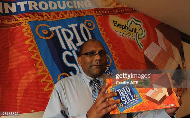 Vice President of Sri Lanka's largest ice cream maker, Elephant House, Neil Samarasinghe poses with a packet of a new triple deck ice cream during a...