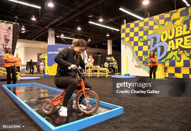 Olympian Ice Dancers Maia Shibutani and Alex Shibutani experience the Double Dare obstacle course at Nickelodeon's booth at 2018 VidCon at Anaheim...