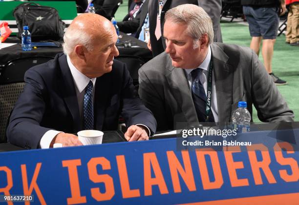 President of Hockey Operations Lou Lamoriello of the New York Islanders talks with Garth Snow during the first round of the 2018 NHL Draft at...