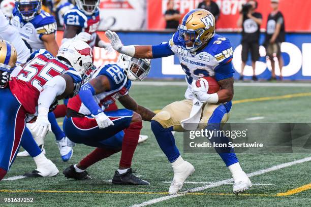 Winnipeg Blue Bombers Running back Andrew Harris runs towards Montreal Alouettes players with the ball during the Winnipeg Blue Bombers versus the...