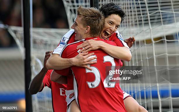 Arsenal's French midfielder Samir Nasri celebrates scoring the opening goal with Danish forward Nicklas Bendtner during the English Premier League...