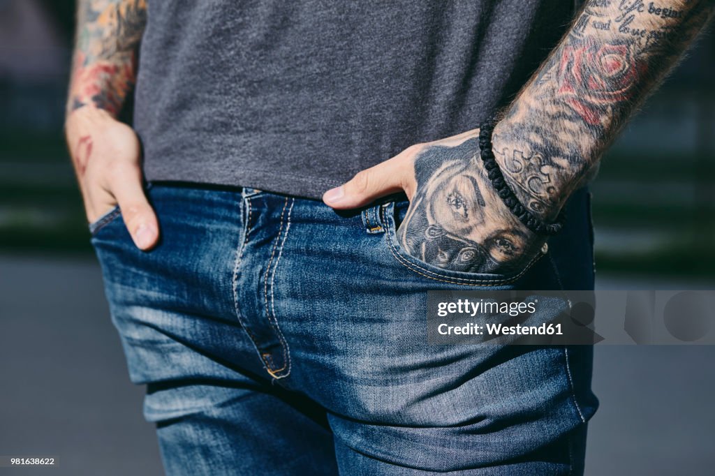 Tattooed arms of a young man outdoors