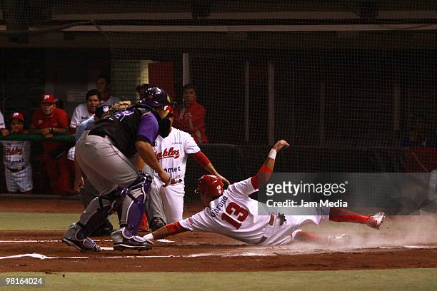 Carlos Rodriguez of Dorados and Oscar Robles of Red Devils during their match as part of the 2010 Baseball Mexican League Tournament at Sol Stadium...