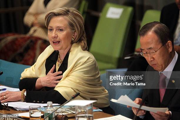 Secretary of State Hillary Rodham Clinton speaks as U.N. Secretary-General Ban Ki-moon looks on during the opening session of the "International...