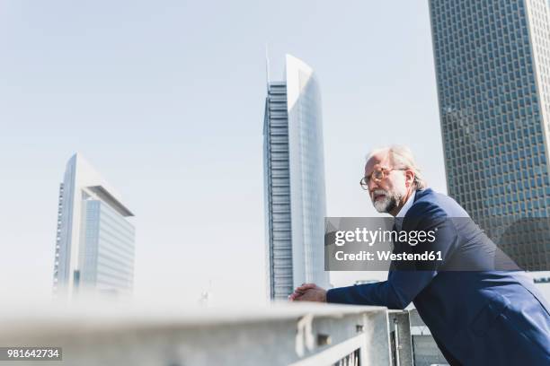 serious mature businessman in the city looking around - frankfurt germany skyline stock pictures, royalty-free photos & images