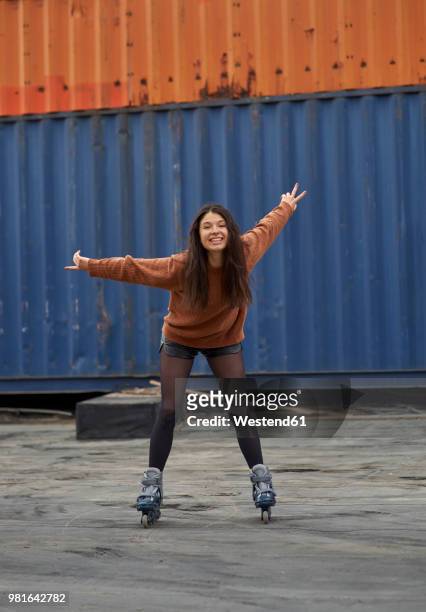 portrait of young inline-skater at industrial area - beugen oder biegen stock-fotos und bilder