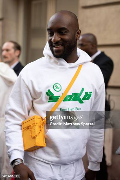 Virgil Abloh is seen on the street during Paris Men's Fashion Week S/S 2019 wearing a white hoodie with yellow cross-body bag on June 22, 2018 in...