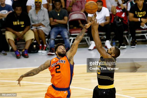Andre Emmett of 3's Company attempts to block the shot of Alan Anderson of Killer 3s during week one of the BIG3 three on three basketball league at...