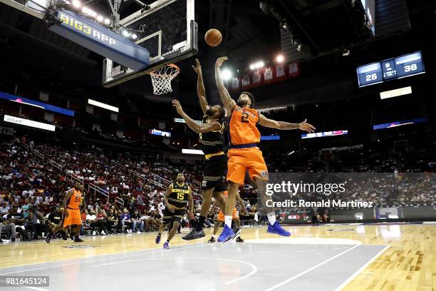 Andre Emmett of 3's Company blocks the shot of Alan Anderson of Killer 3s during week one of the BIG3 three on three basketball league at Toyota...