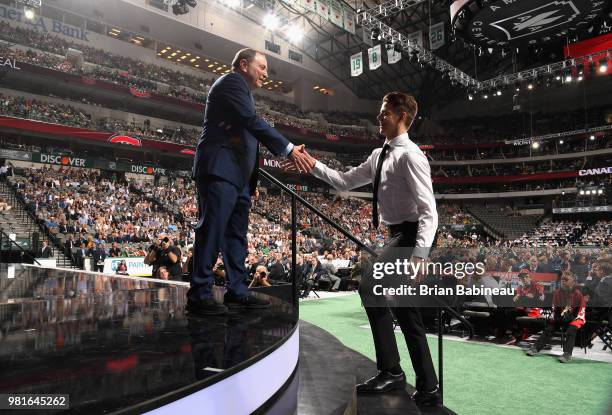 Jesperi Kotkaniemi shakes the hand of NHL Commissioner Gary Bettman after being selected third overall by the Montreal Canadiens during the first...