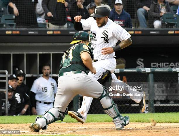 Omar Narvaez of the Chicago White Sox is safe at home as Josh Phegley of the Oakland Athletics makes a late tag during the second inning in game two...