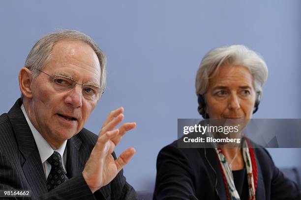 Wolfgang Schaeuble, Germany's finance minister, left, speaks as Christine Lagarde, France's finance minister, listens after a meeting of the German...