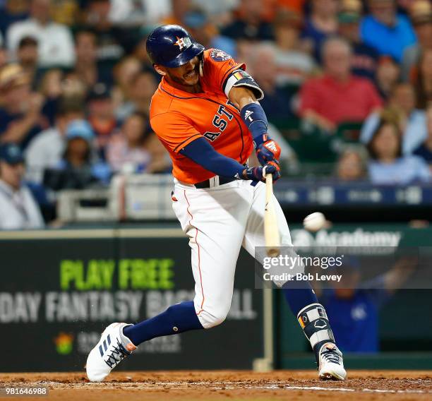 Carlos Correa of the Houston Astros doubles in the second inning against the Kansas City Royals at Minute Maid Park on June 22, 2018 in Houston,...
